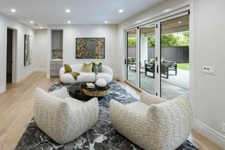 Family room beside wide folding glass doors opening toward the covered garden terrace.
